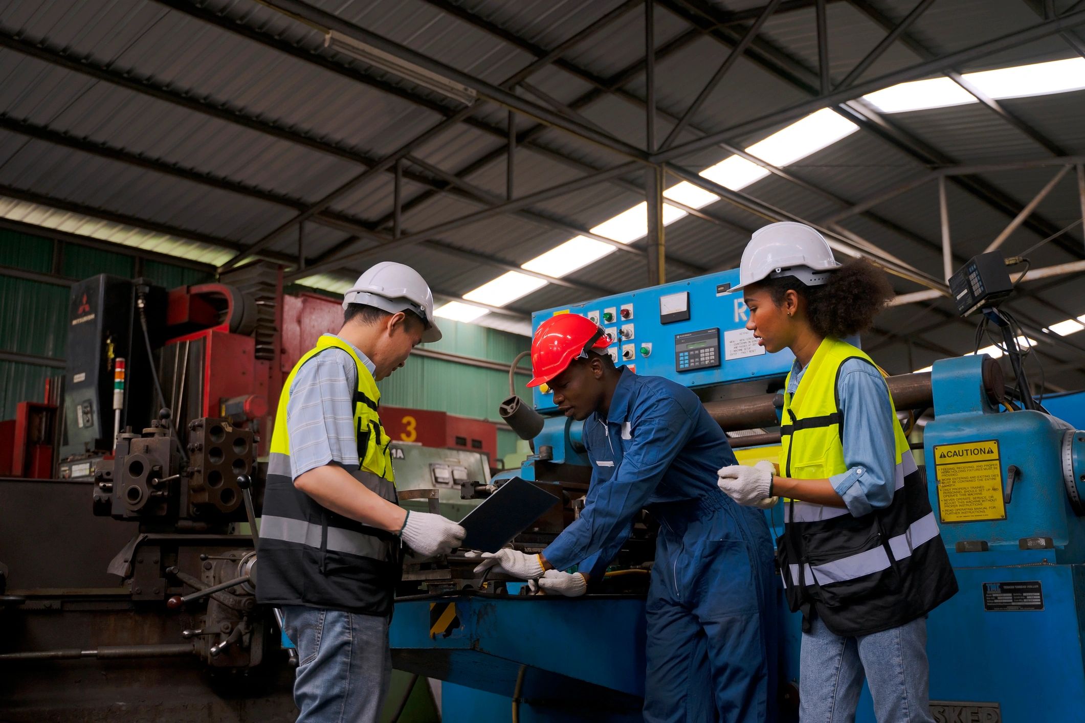 Factory team working on production machinery