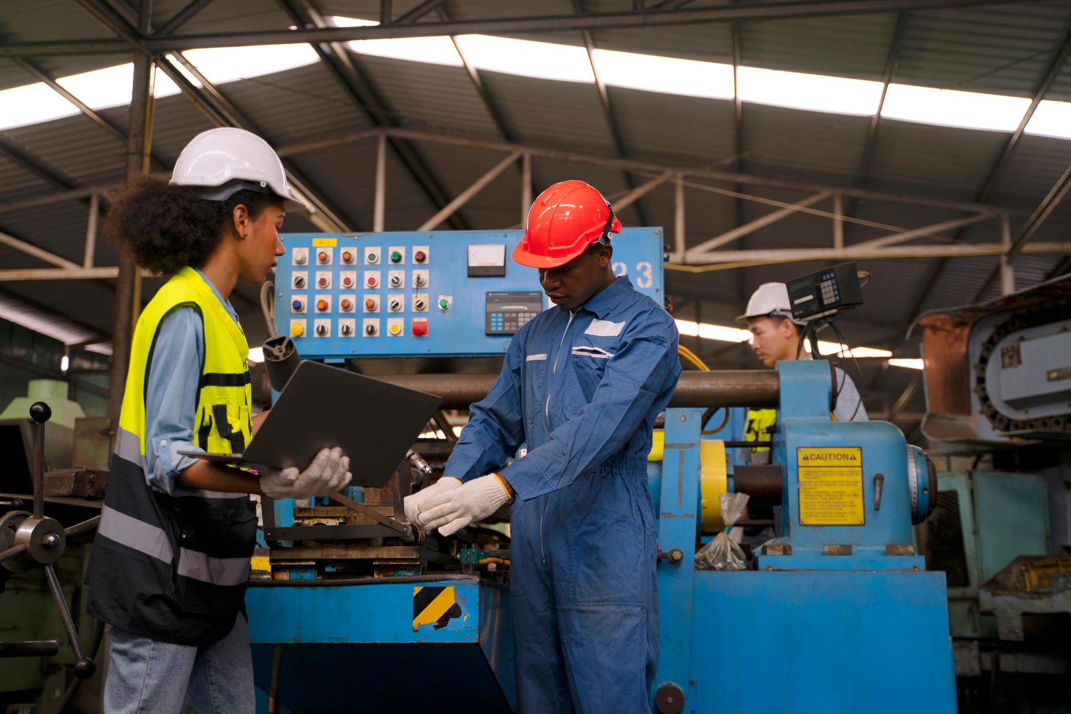 Factory workers operating machinery in a manufacturing facility